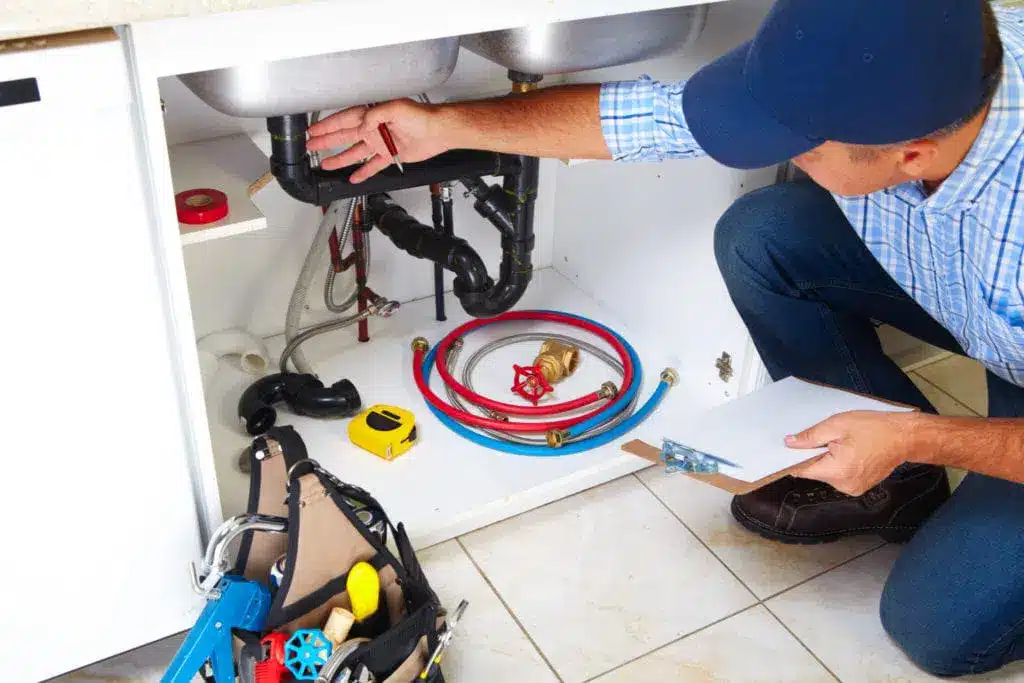 man fixing drain line